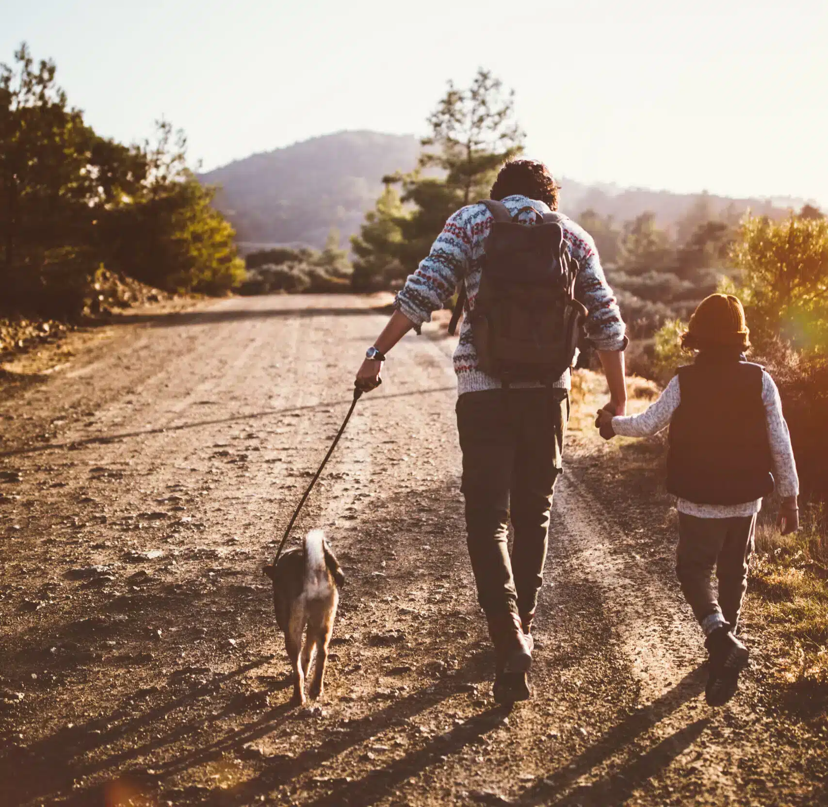 Father and son walking their dog